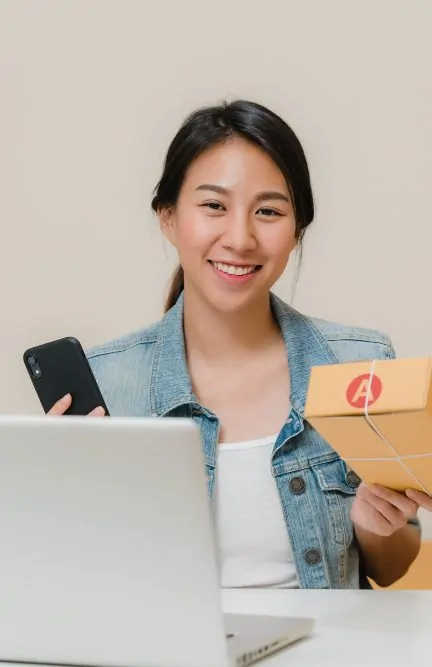 Ecommerce business owner preparing a package for shipping using 3PL logistics and fulfillment services.