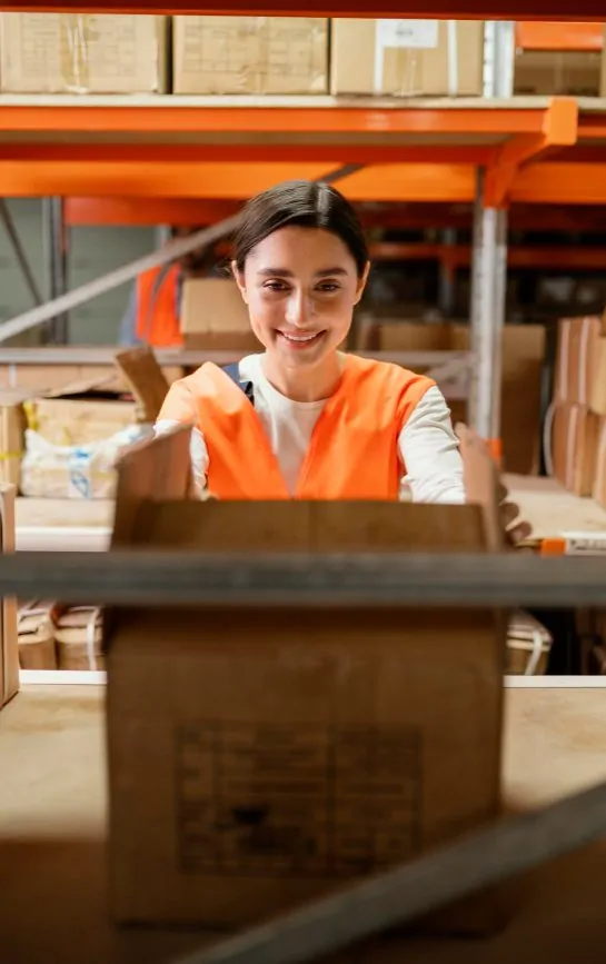 Warehouse employee organizing packages for ecommerce fulfillment and 3PL logistics operations.